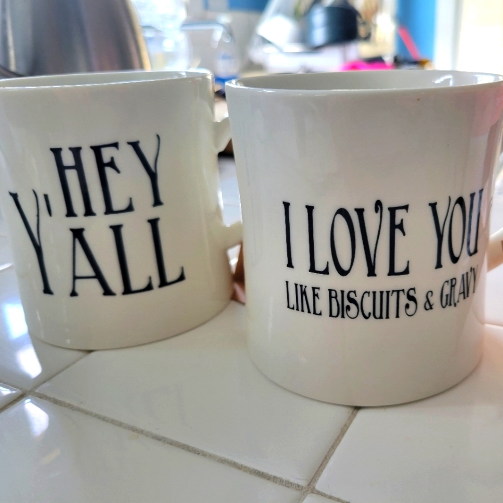 2 large coffee mugs glazed "hey y'all" and "I love you like Biscuits and Gravy"